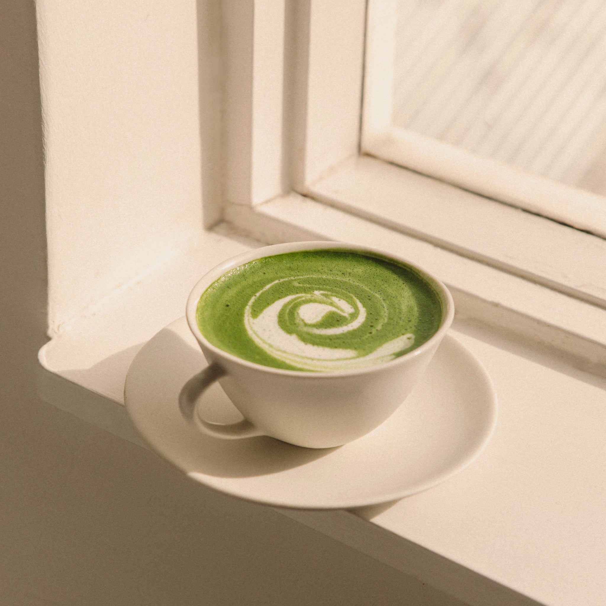 Organic ceremonial matcha latte on window sill